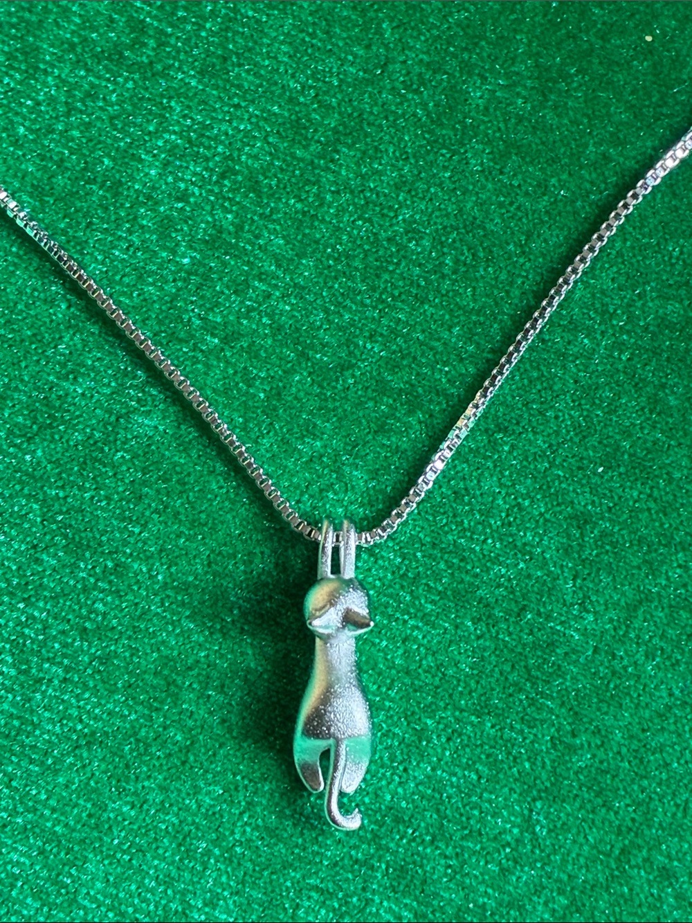 Adorable playful Kitty cat hanging from a chain necklace in hammered silvertone
